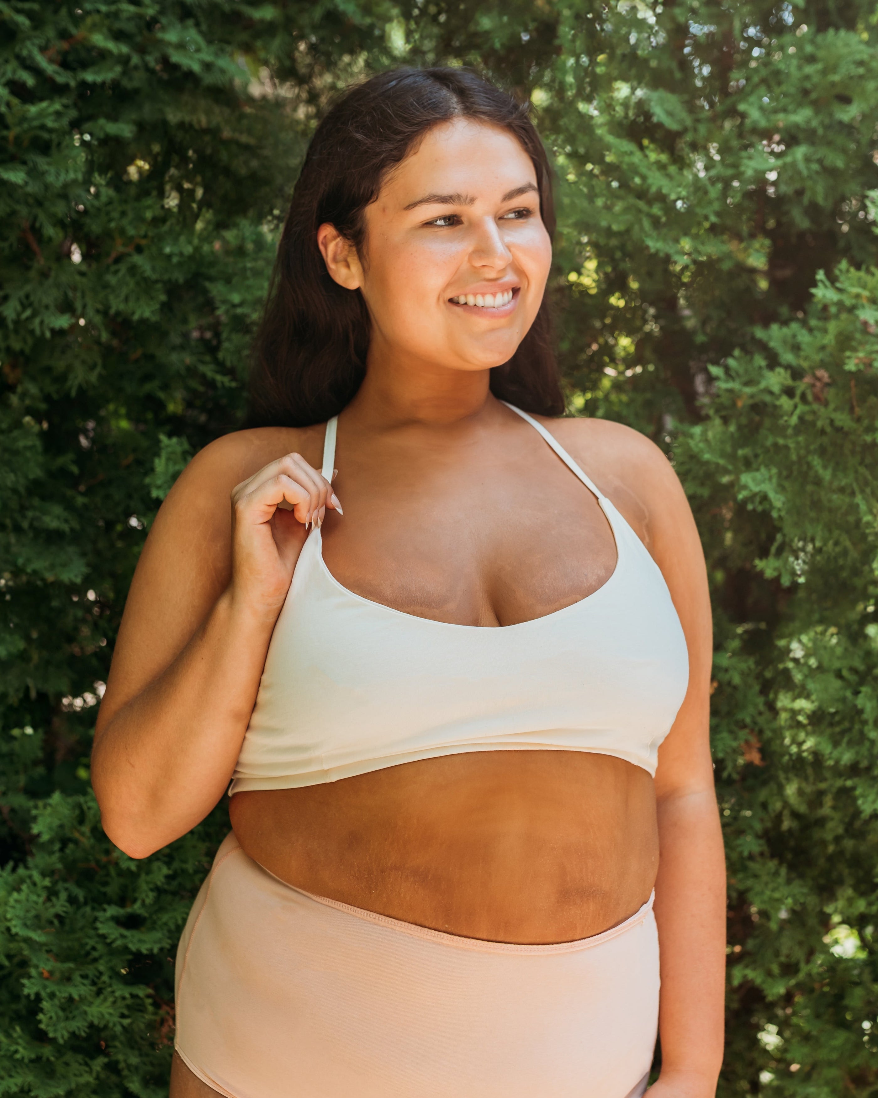 Woman outdoors smiling in Pure (no dye) Women's Criss-Cross Organic Cotton Bralette in undyed natural | Q for Quinn
