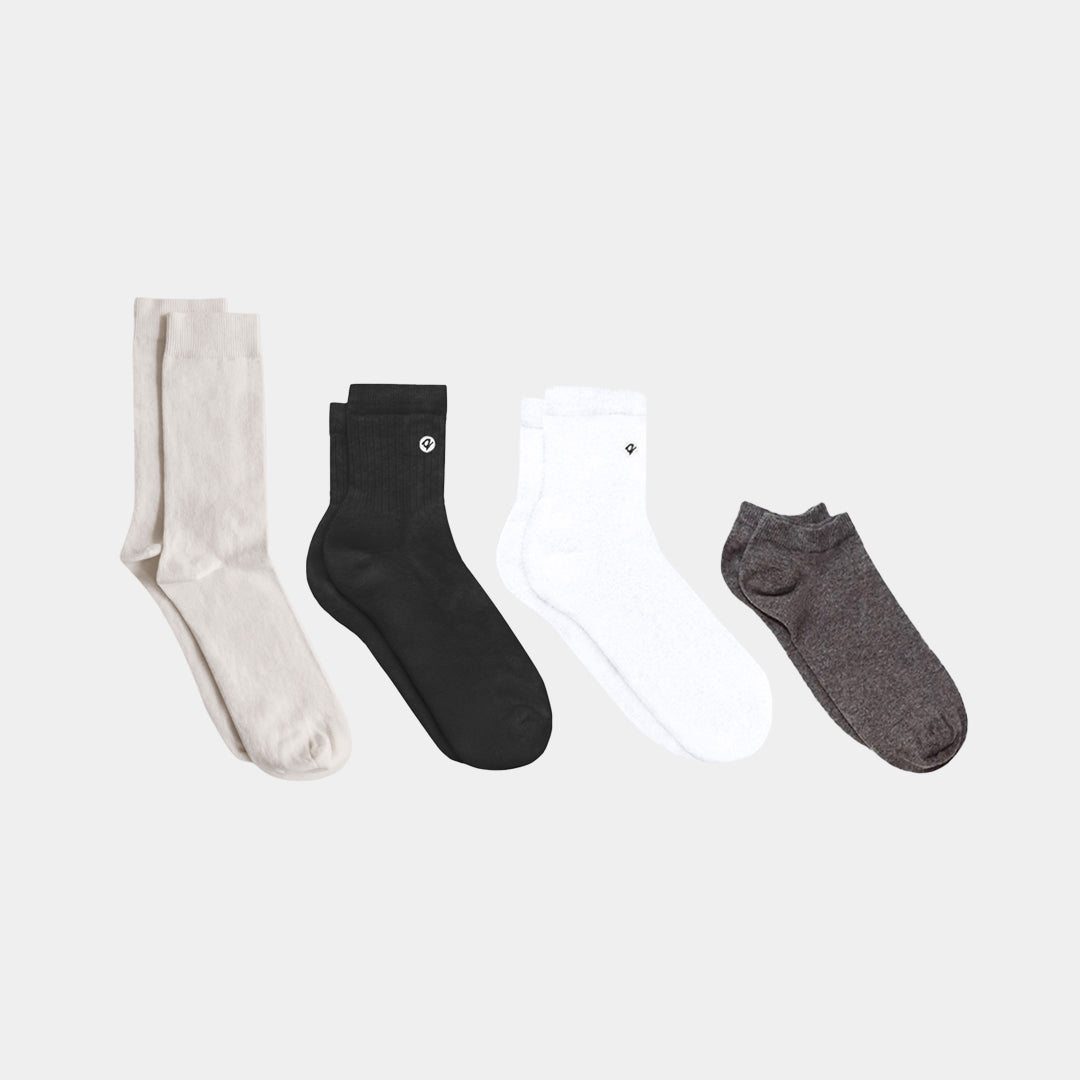 Organic cotton socks in four styles: cream crew, black ankle, white quarter, and gray no-show | Q for Quinn