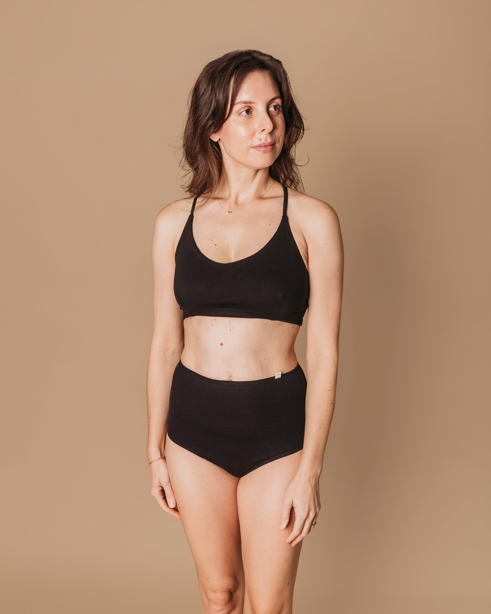 Model wearing Women's High Waist Brief in Black, front view against neutral background | Q for Quinn