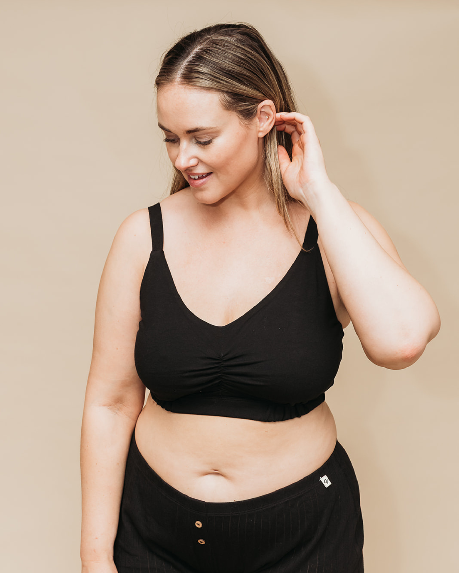 Woman wearing a black Full Bust Sports Bra and black Pointelle Boxers