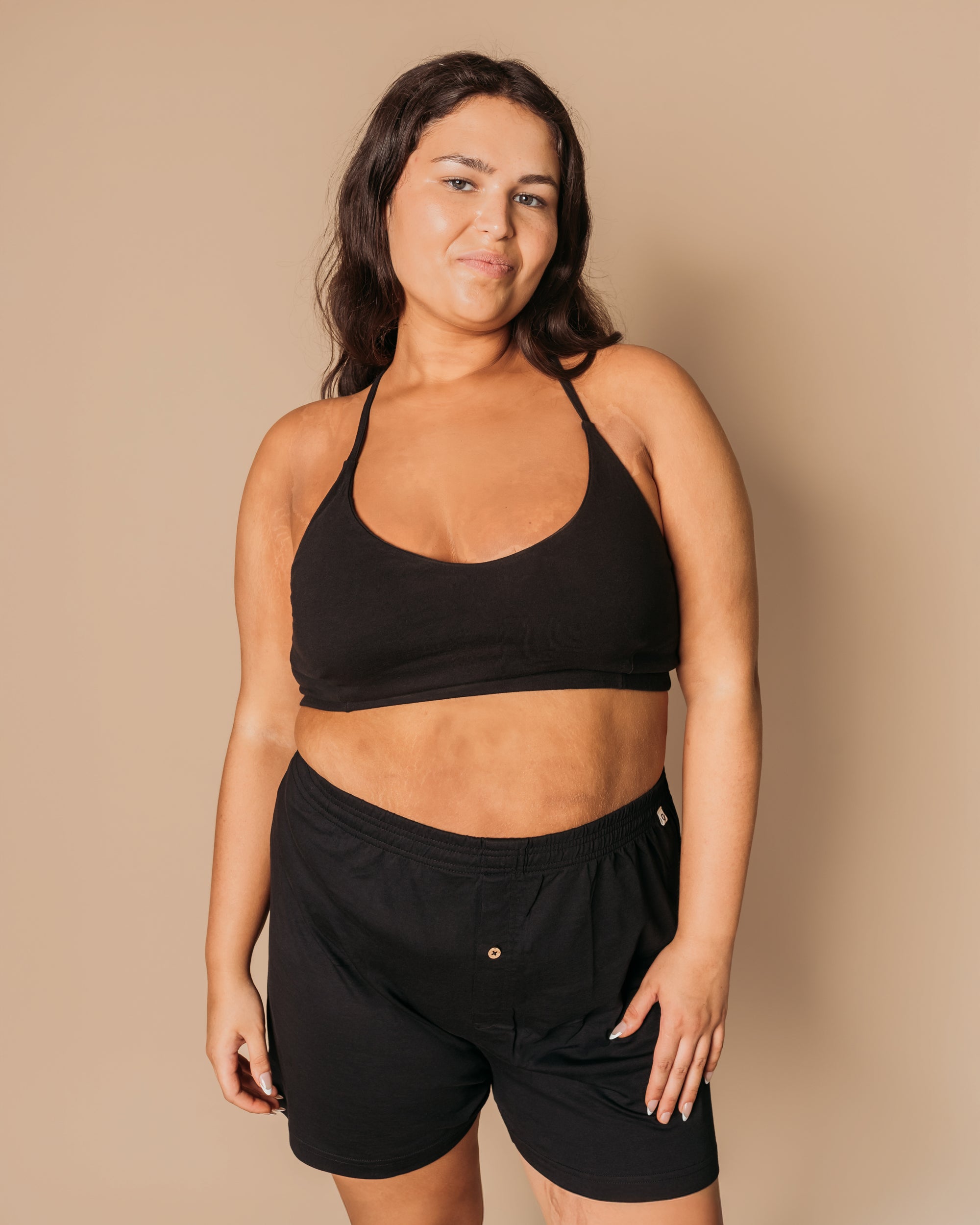 Plus-size model wearing Everyday Knit Boxers in black with matching black organic cotton bralette | Q for Quinn