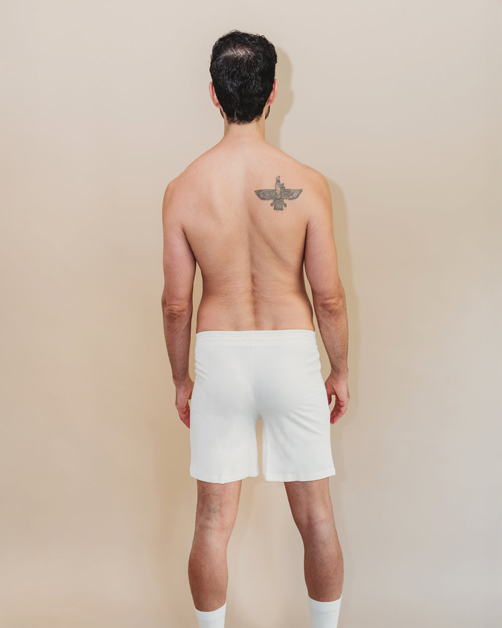 Back view of man wearing Everyday Knit Organic Cotton Boxers in Natural, bird tattoo visible | Q for Quinn