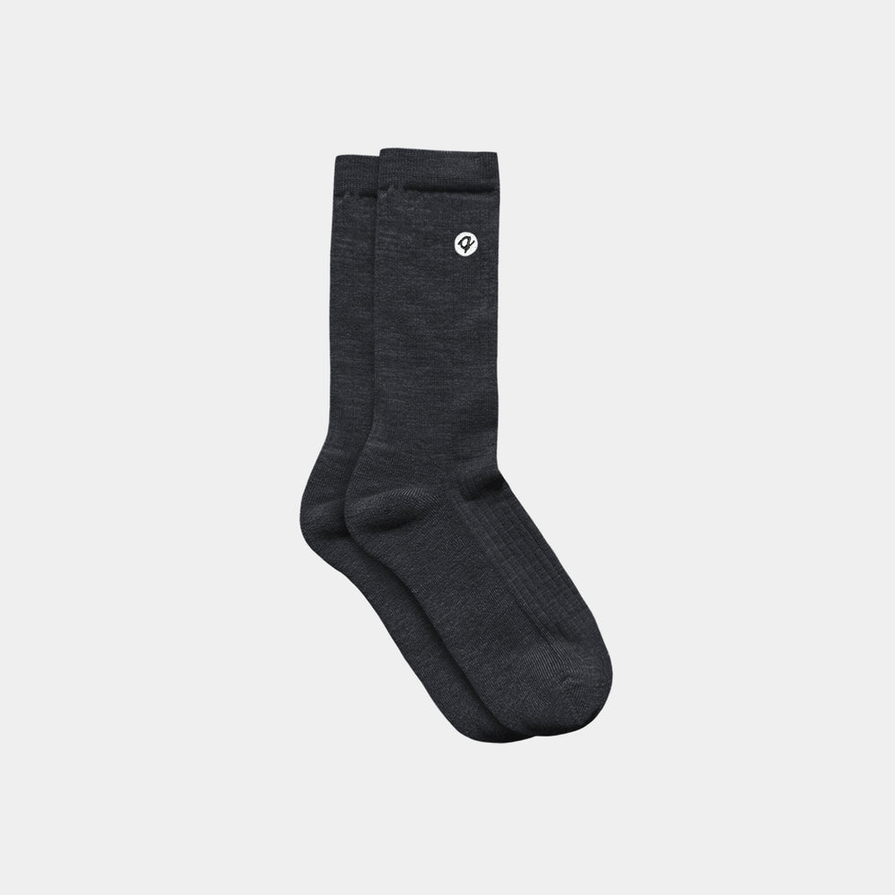 Pair of dark gray socks with a logo on a light gray background