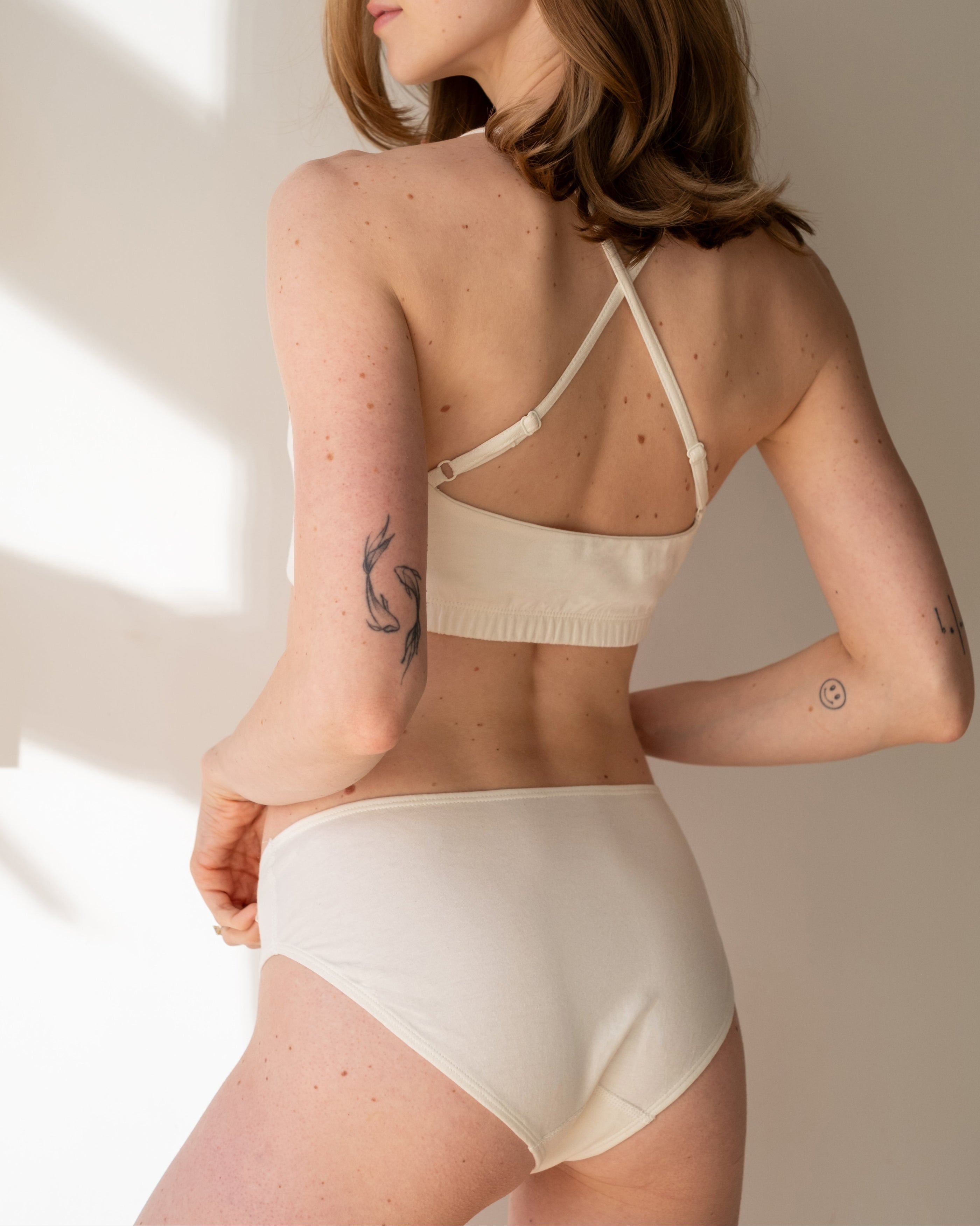 Back view of Womens Everyday Organic Cotton Bikini in Natural paired with a crossback bralette | Q for Quinn
