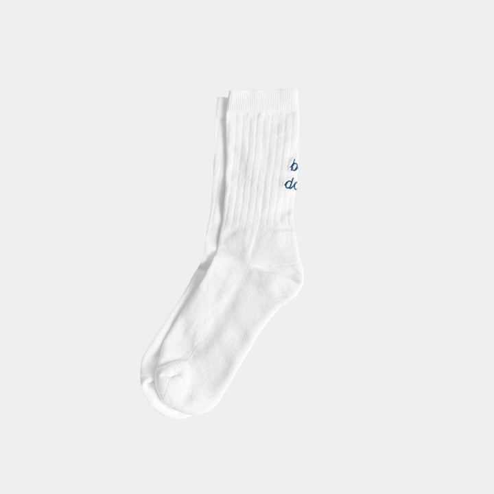 White sock with blue text on a light gray background