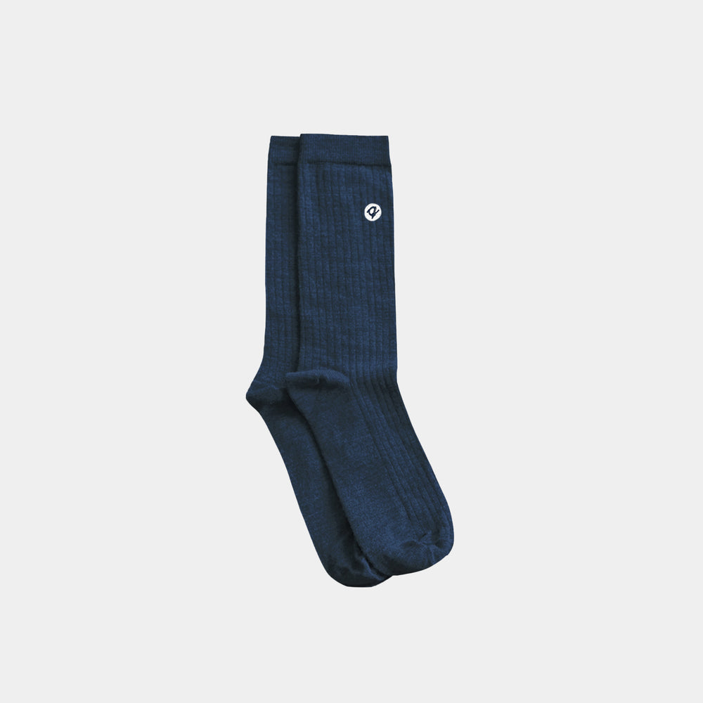 Blue sock with a white logo on a light gray background