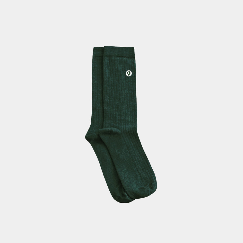 Green sock with a logo on a light gray background
