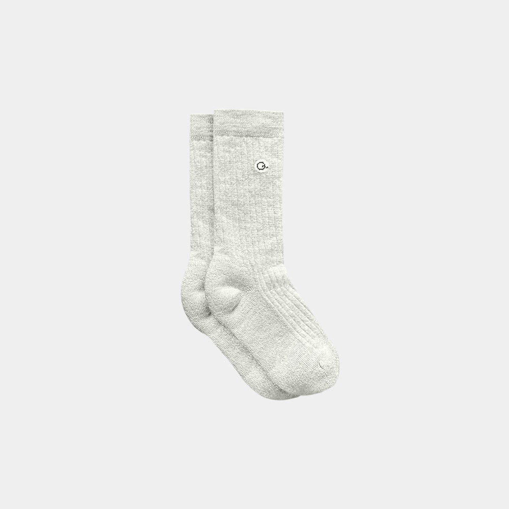 Pair of gray socks on a light gray background