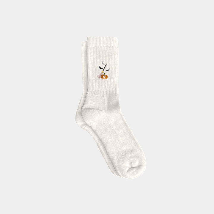 White sock with a small design on a light gray background