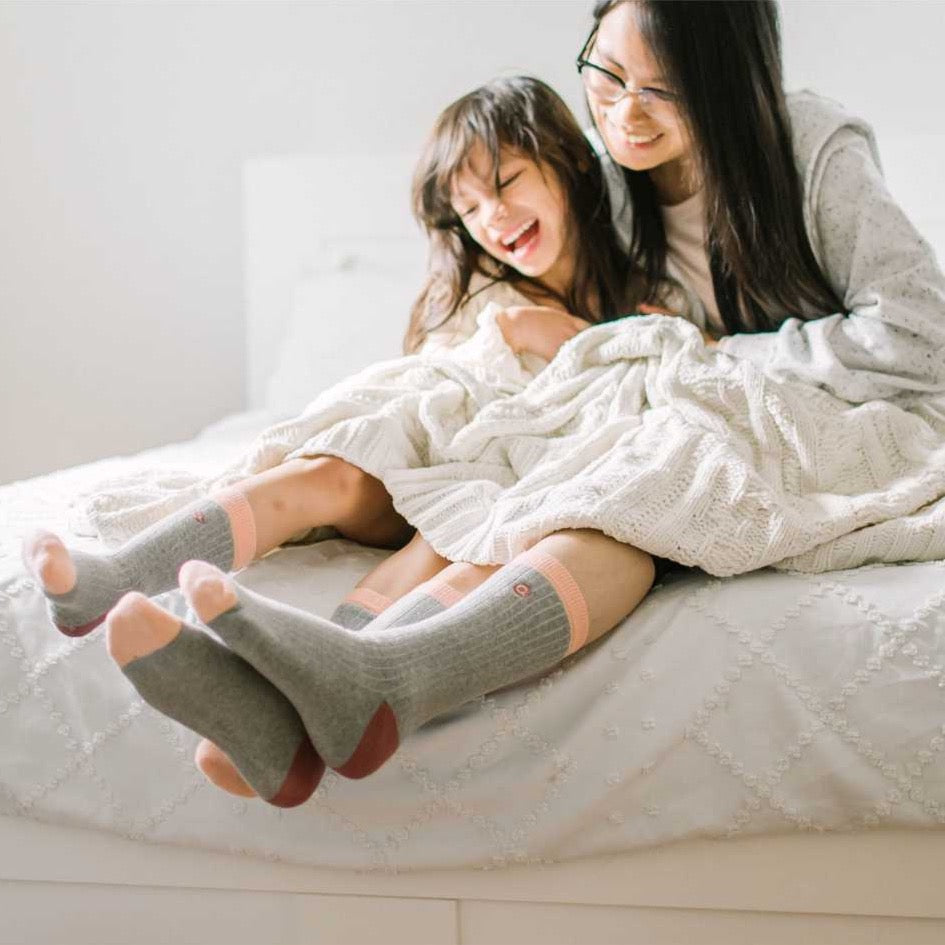 Mother and daughter wearing matching socks 