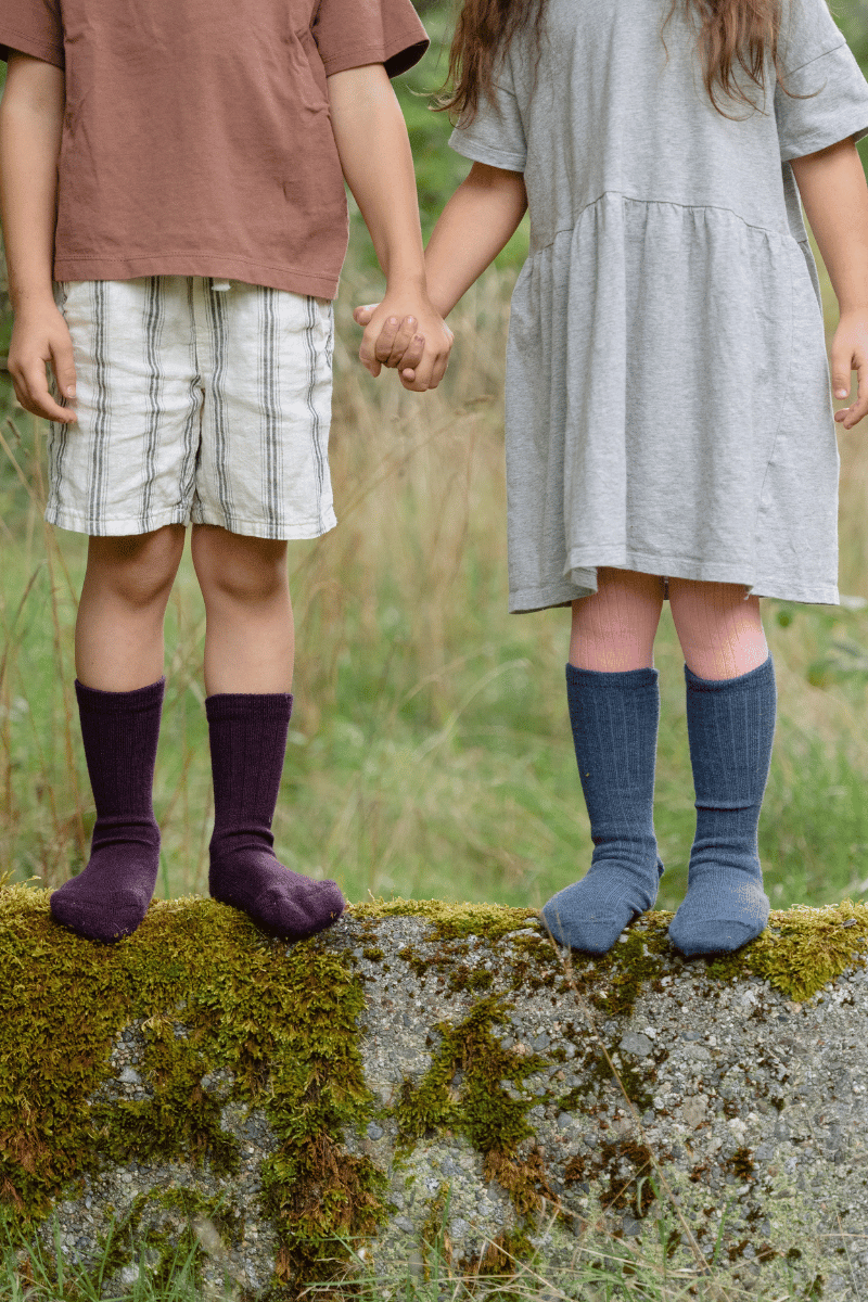 Two children hold hands