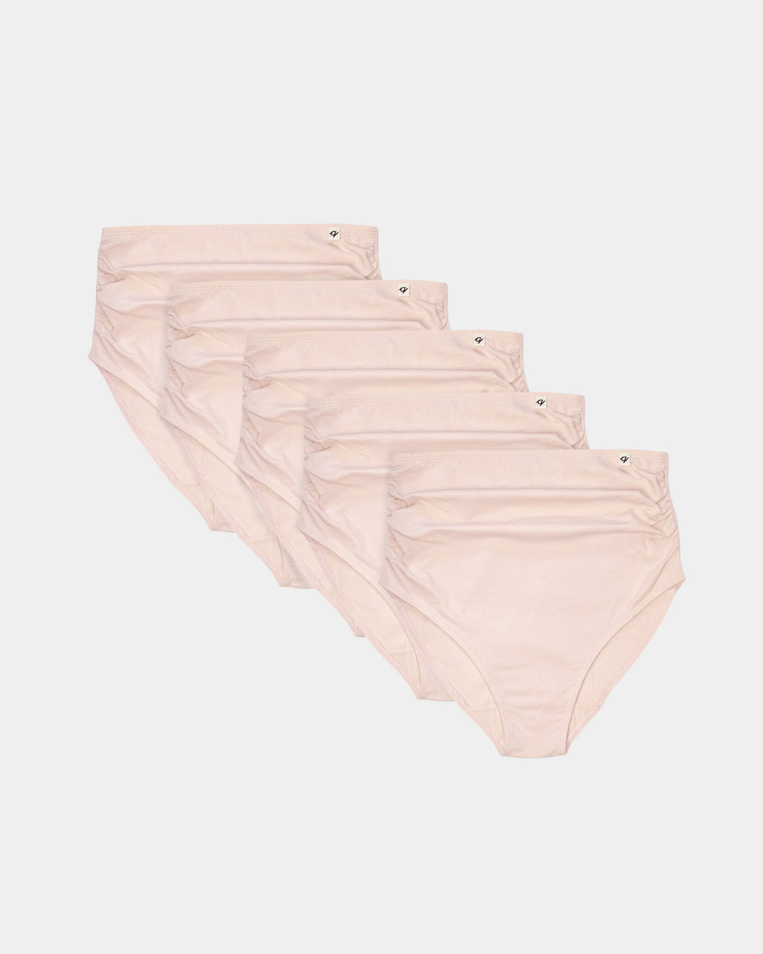 Set of five pairs of blush pink underwear on a white background