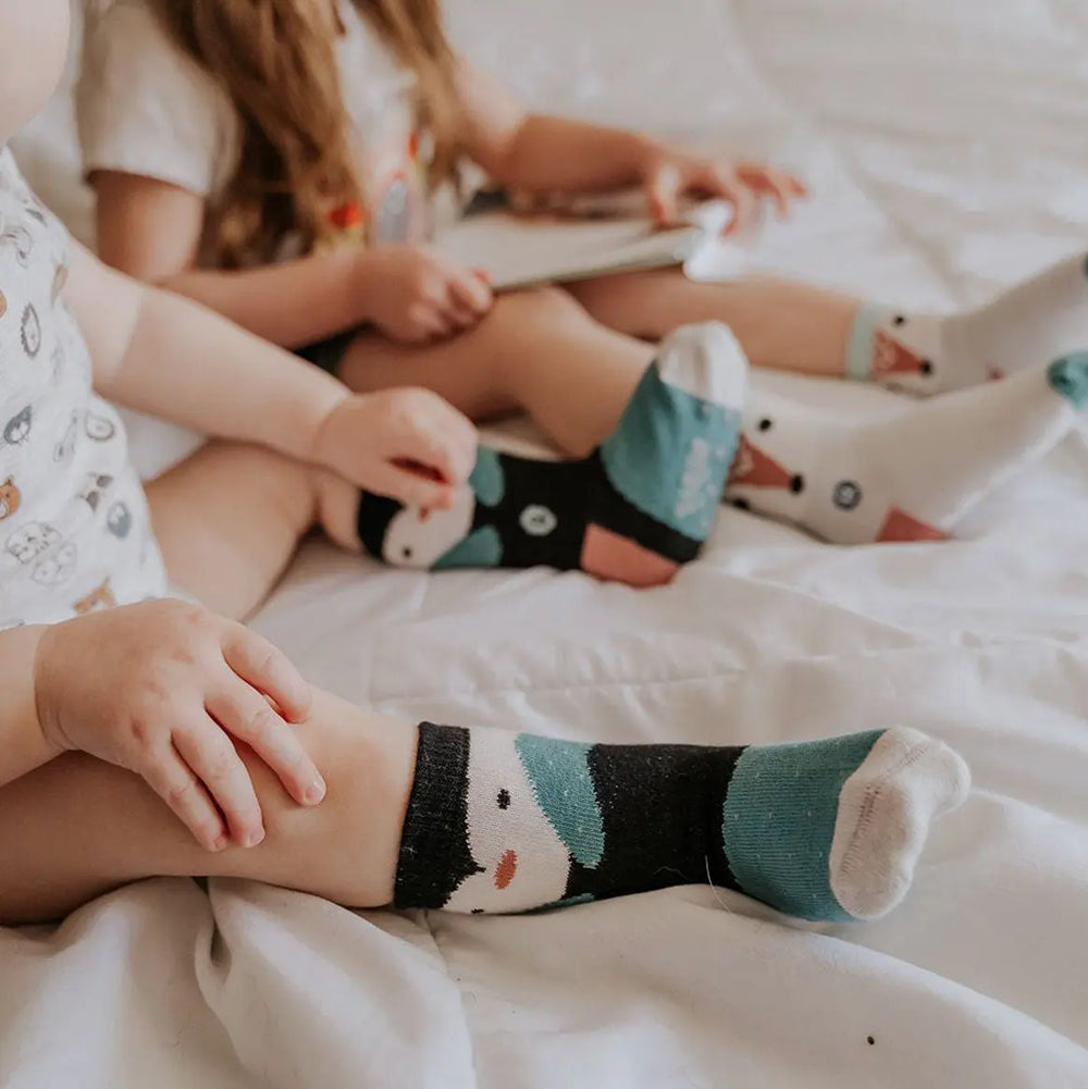 Little girls wearing organic cotton penguin socks