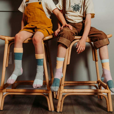 2 Boys Sitting and Wearing Organic Cotton Socks Blocks of Colour