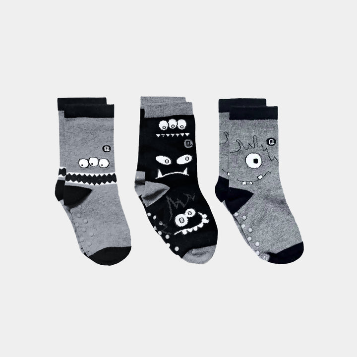 Three pairs of cartoon-themed socks on a light gray background