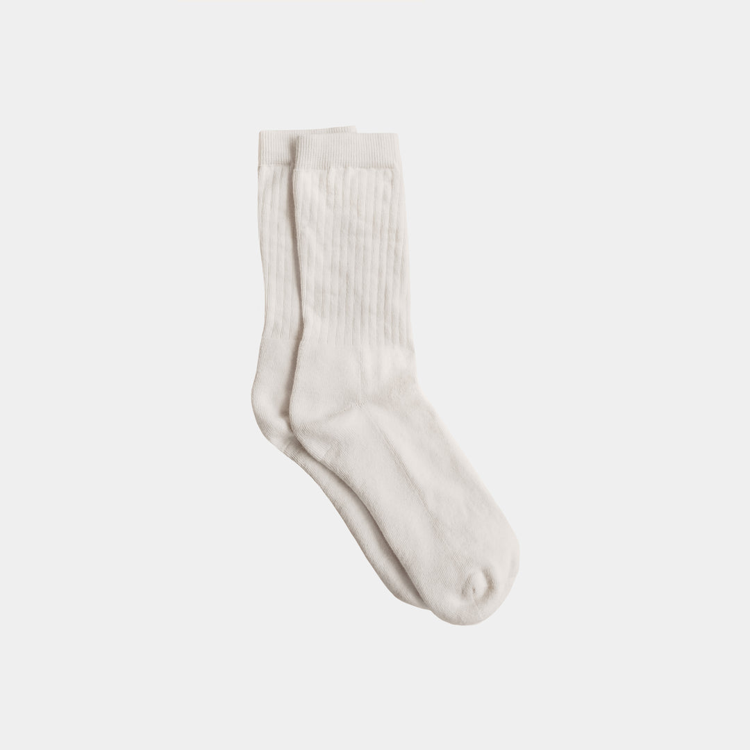 Pair of white socks on a light gray background