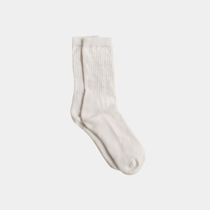 Pair of white socks on a light gray background