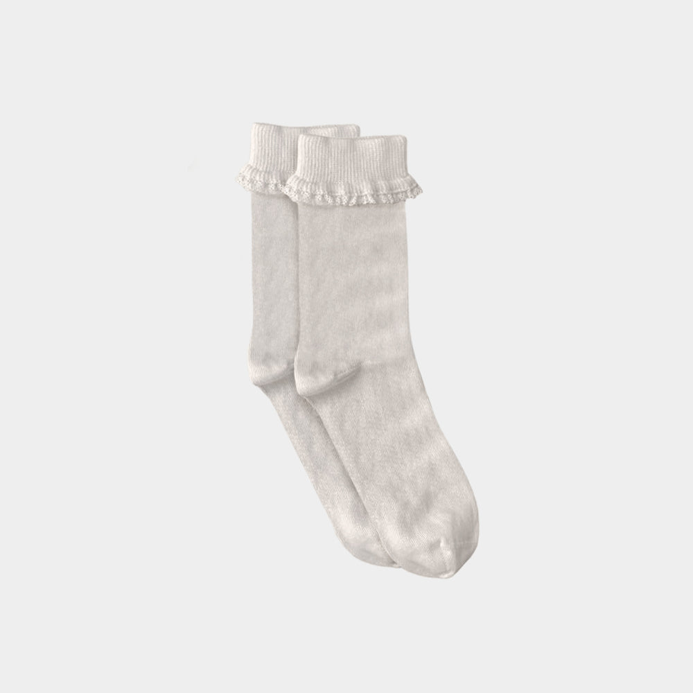 A pair of off-white ribbed ankle socks with delicate ruffled trim at the top, displayed against a solid light gray background.