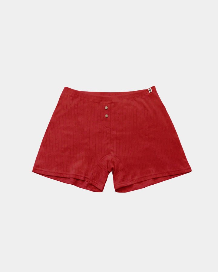 Red ribbed knit shorts with a three-button henley waistband, displayed flat against a light gray background.