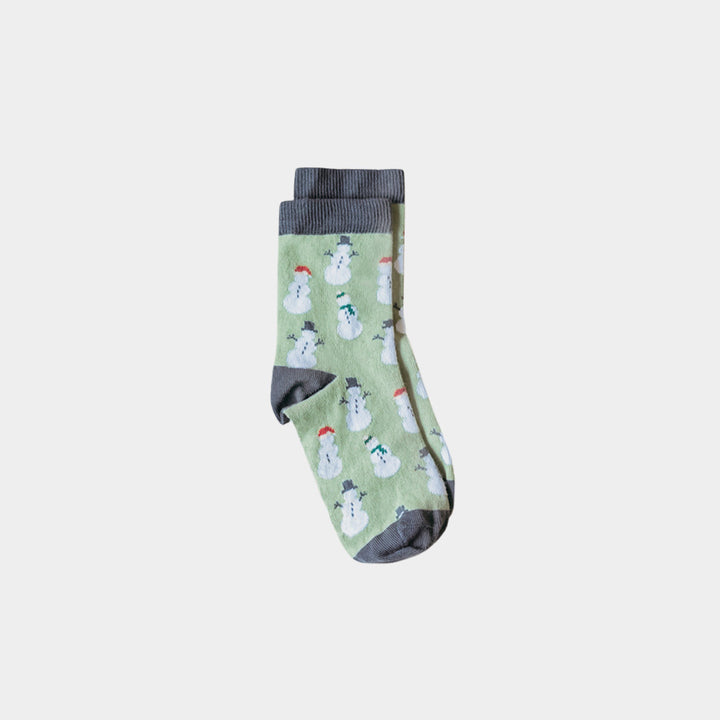 A pair of light green crew socks with a repeating snowman pattern and dark gray ribbed cuffs, heels, and toes, shown against a plain light gray background.