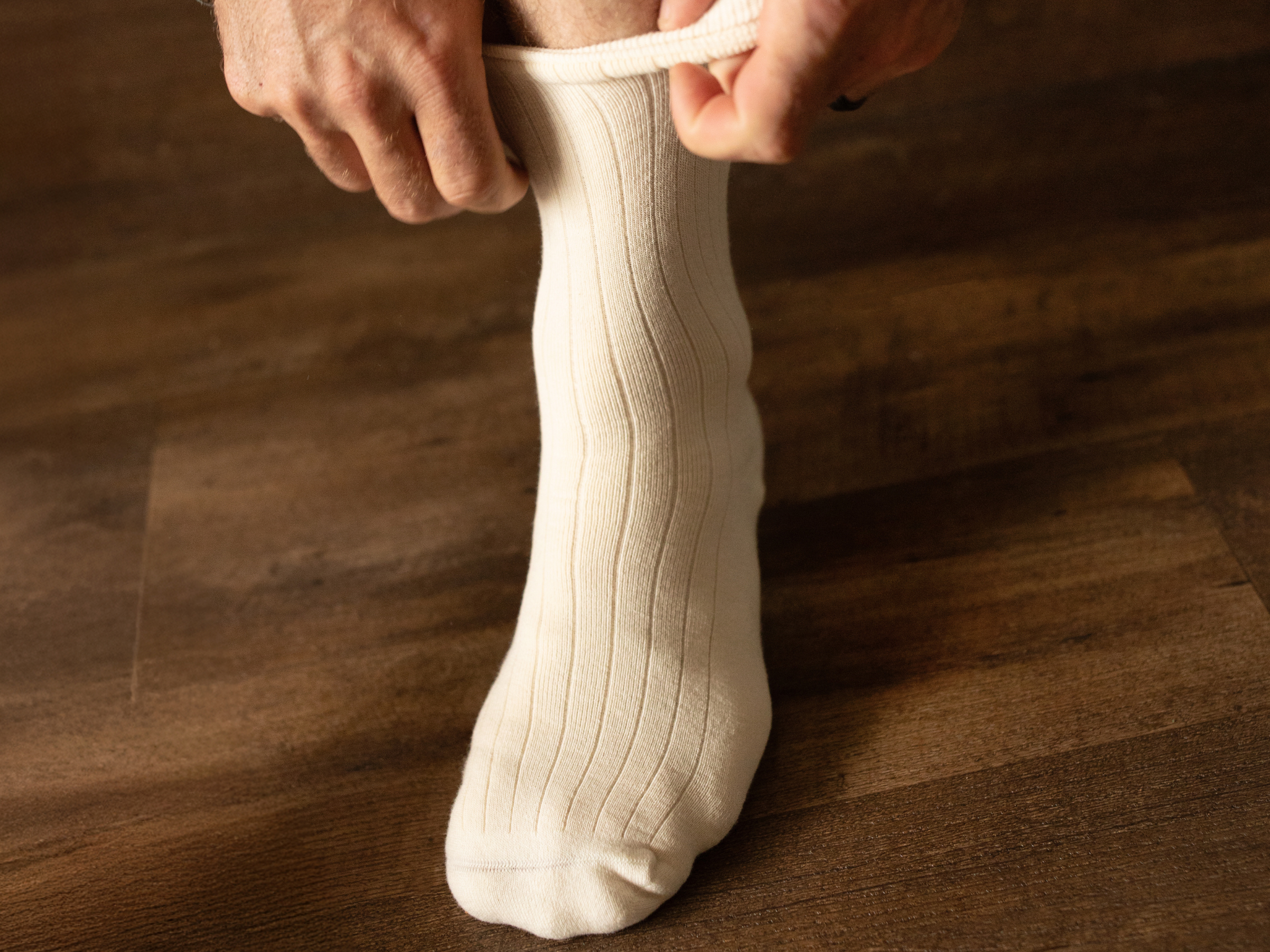 person rolling up socks