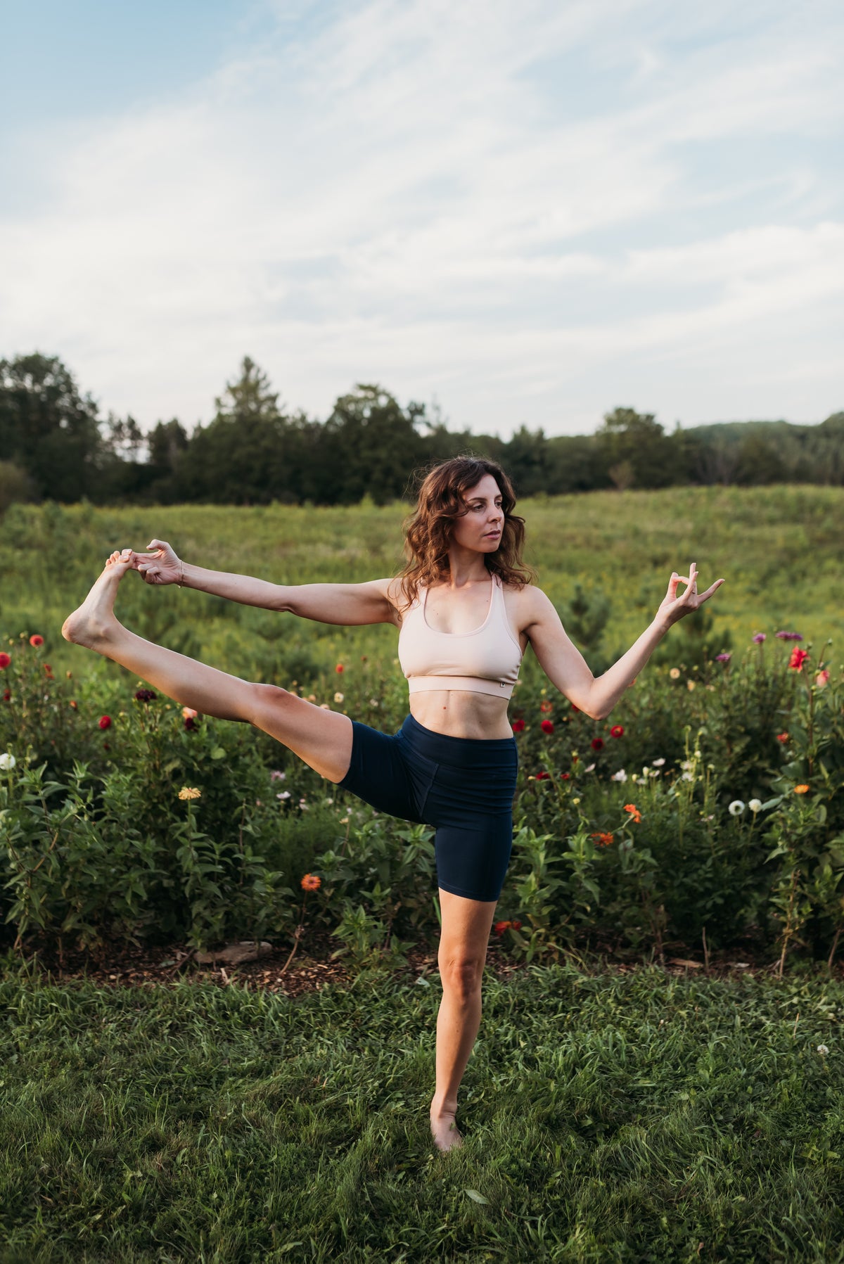 Woman does a yoga pose in a flower farm