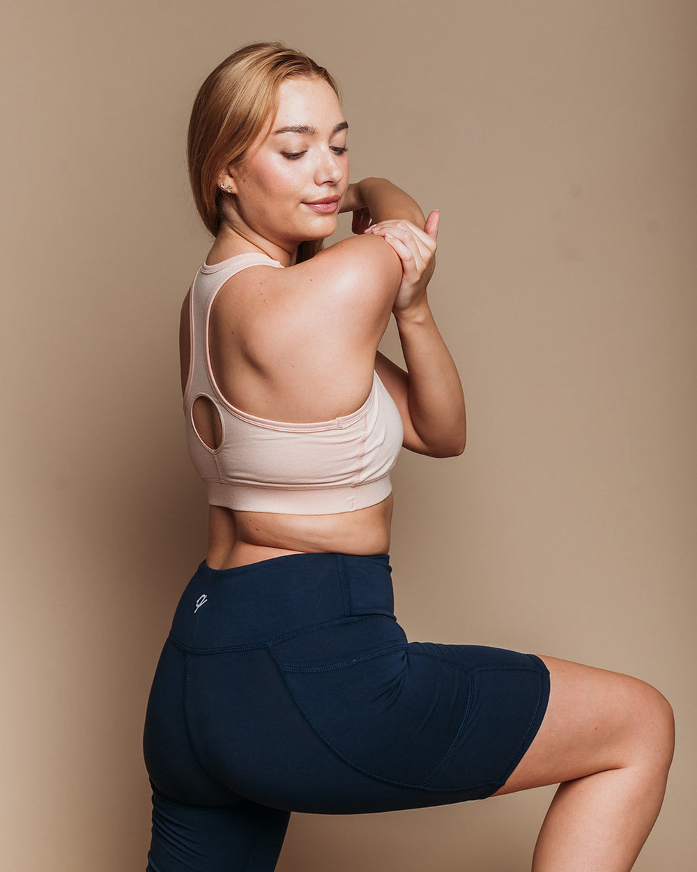 Woman stretching in Biker Shorts and Lilac Racerback Sports Bra