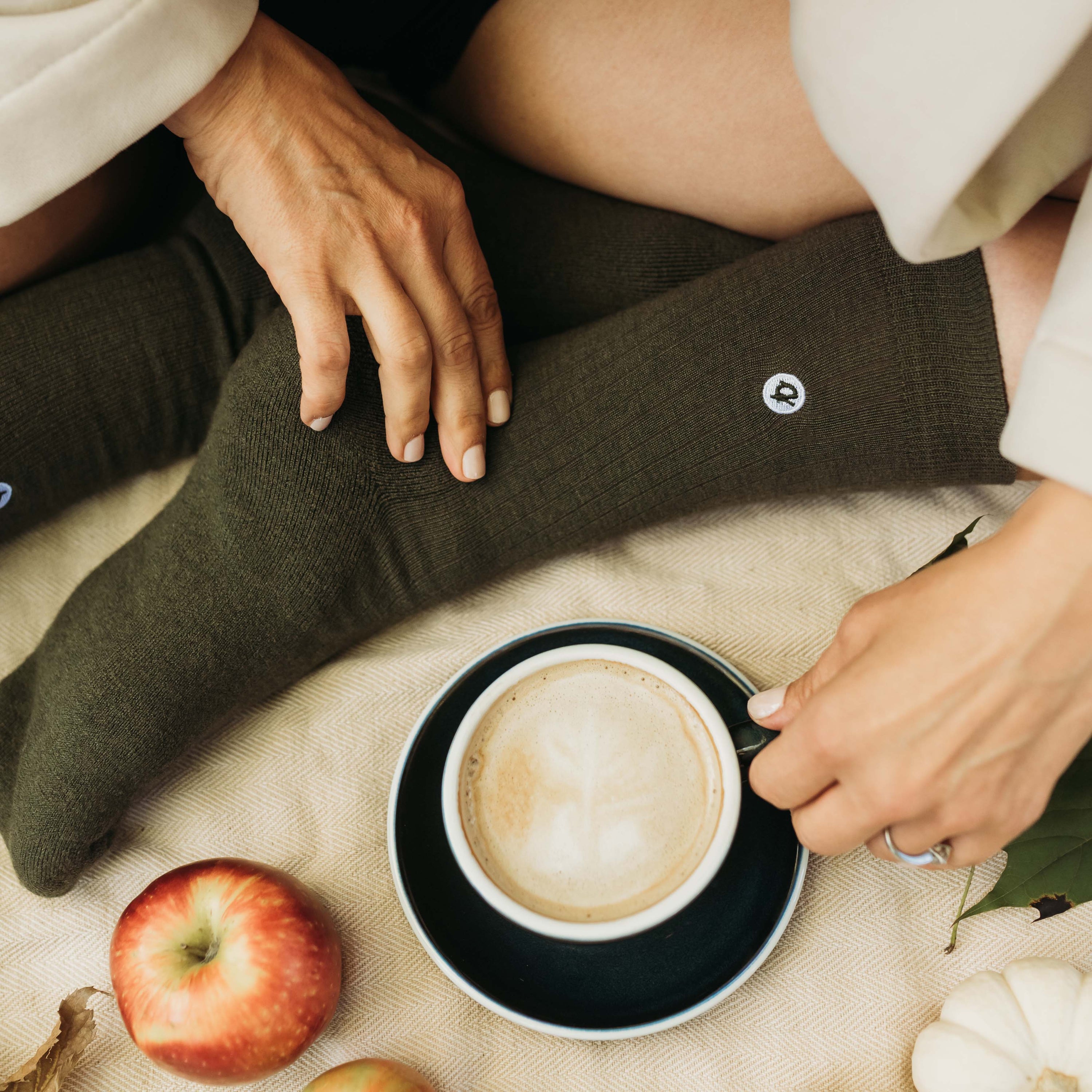 Merino Wool Cotton Midweight Adult Socks Multipack in Moss worn in cozy autumn scene with coffee | Q for Quinn