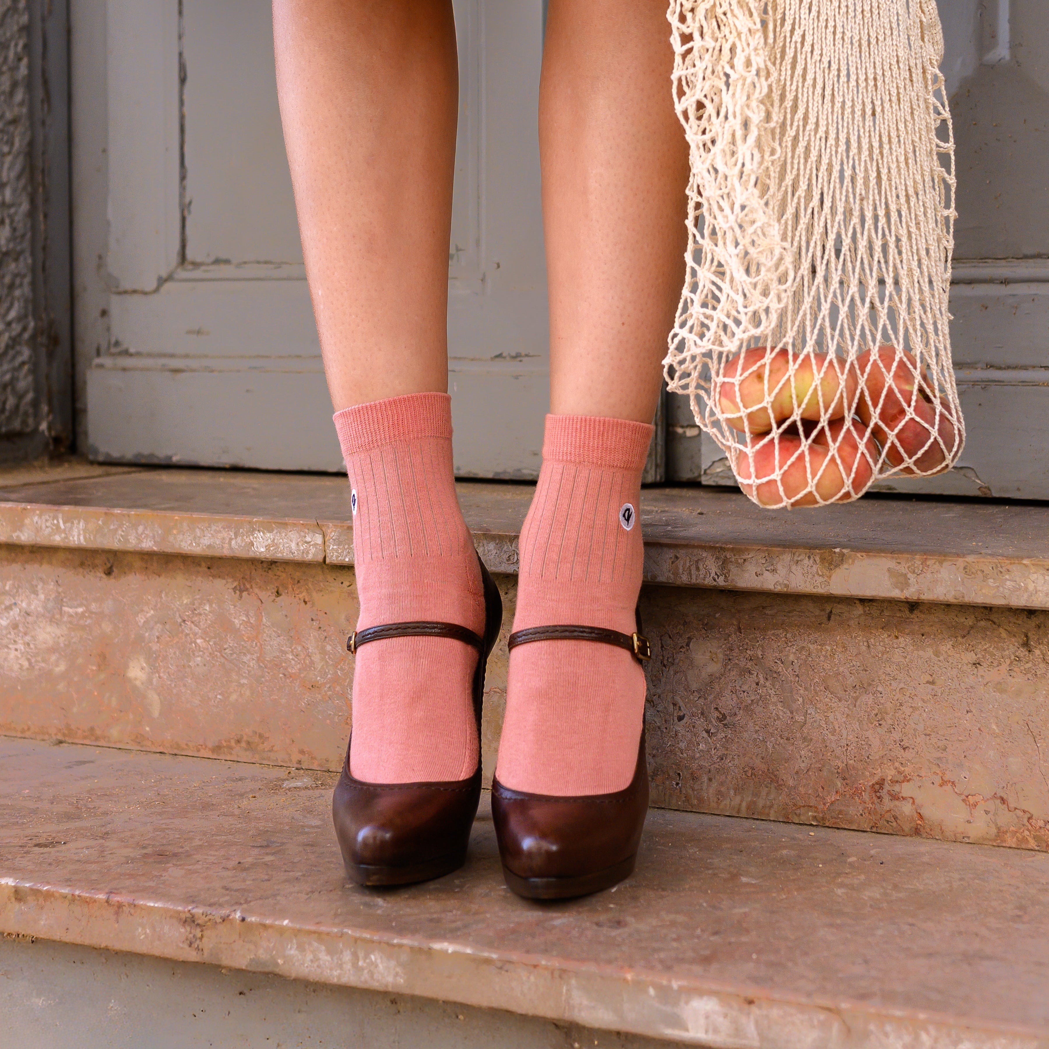 Merino Wool - Cotton Midweight Quarter Pacers in coral - styled with dark Mary Jane heels on stone steps | Q for Quinn