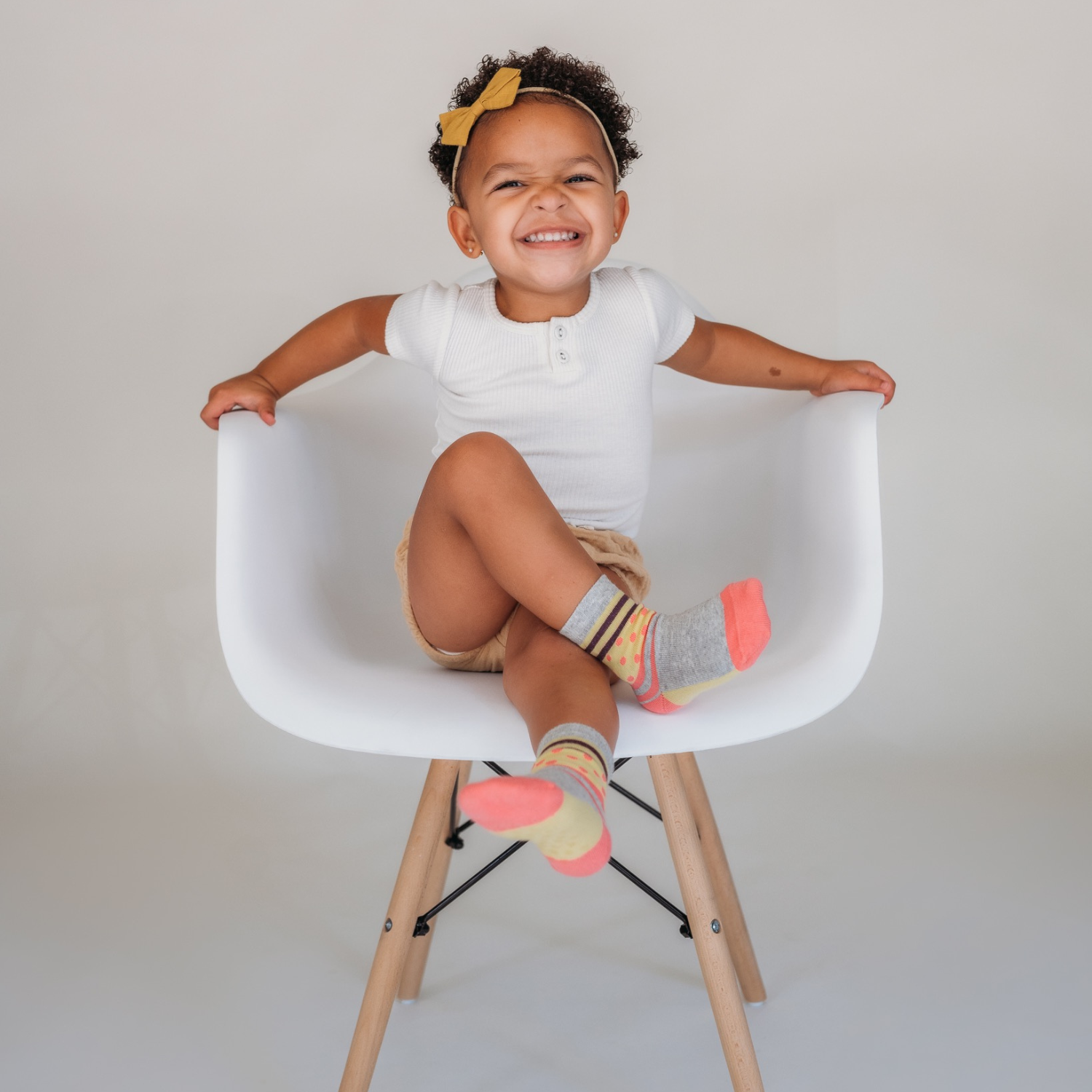 A Little Girl Smiling Wears Organic Cotton Socks 'Types of Stripes'